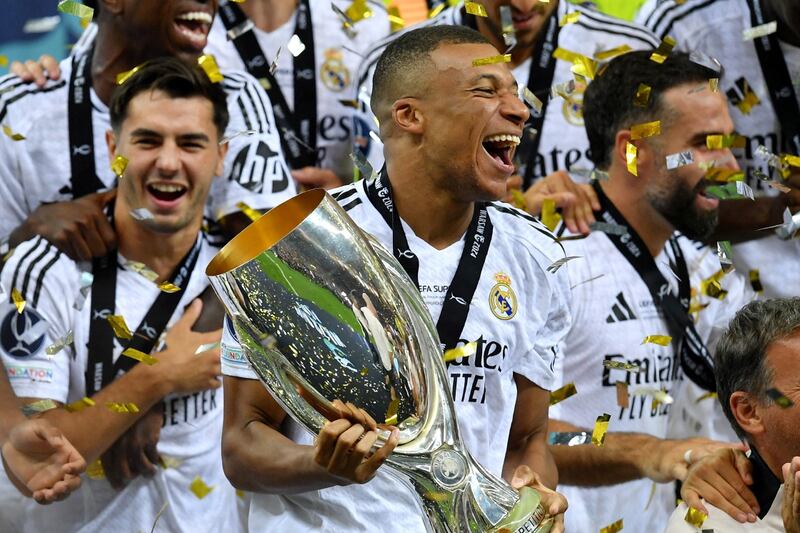 Real Madrid's Kylian Mbappé celebrates with the trophy after winning the Super Cup against Atalanta at National Stadium in Warsaw, Poland on Wednesday night.