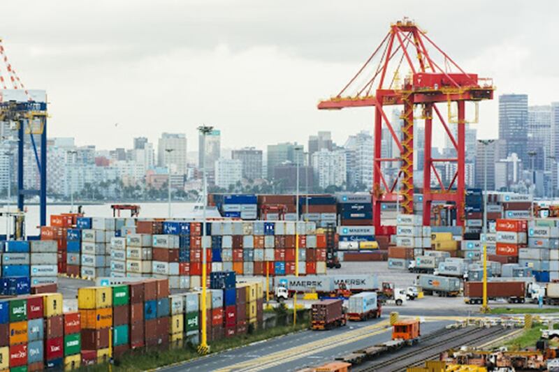 A ship-to-shore crane stands above shipping containers on the dockside at the Port of Durban, operated by Transnet SOC Holdings Ltd.'s Ports Authority, in Durban.