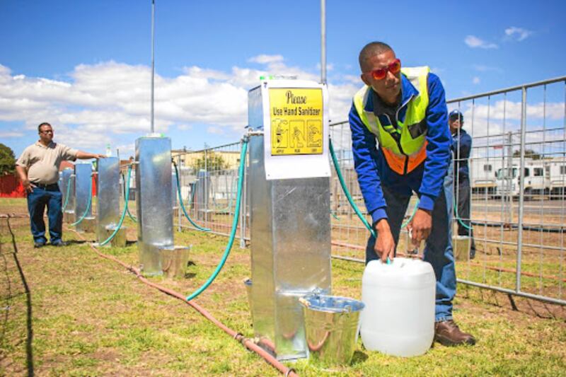 Brandon Herringer, a City of Cape Town plumber, demonstrates what a water collection point would have looked like if Day Zero had arrived.