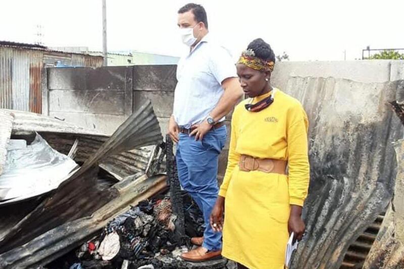 Ward councillor Angus McKenzie and Delft community leader Dineo Masiu inspect the charred remains of the fire that claimed the lives of three members of a family in the early hours of Sunday morning.